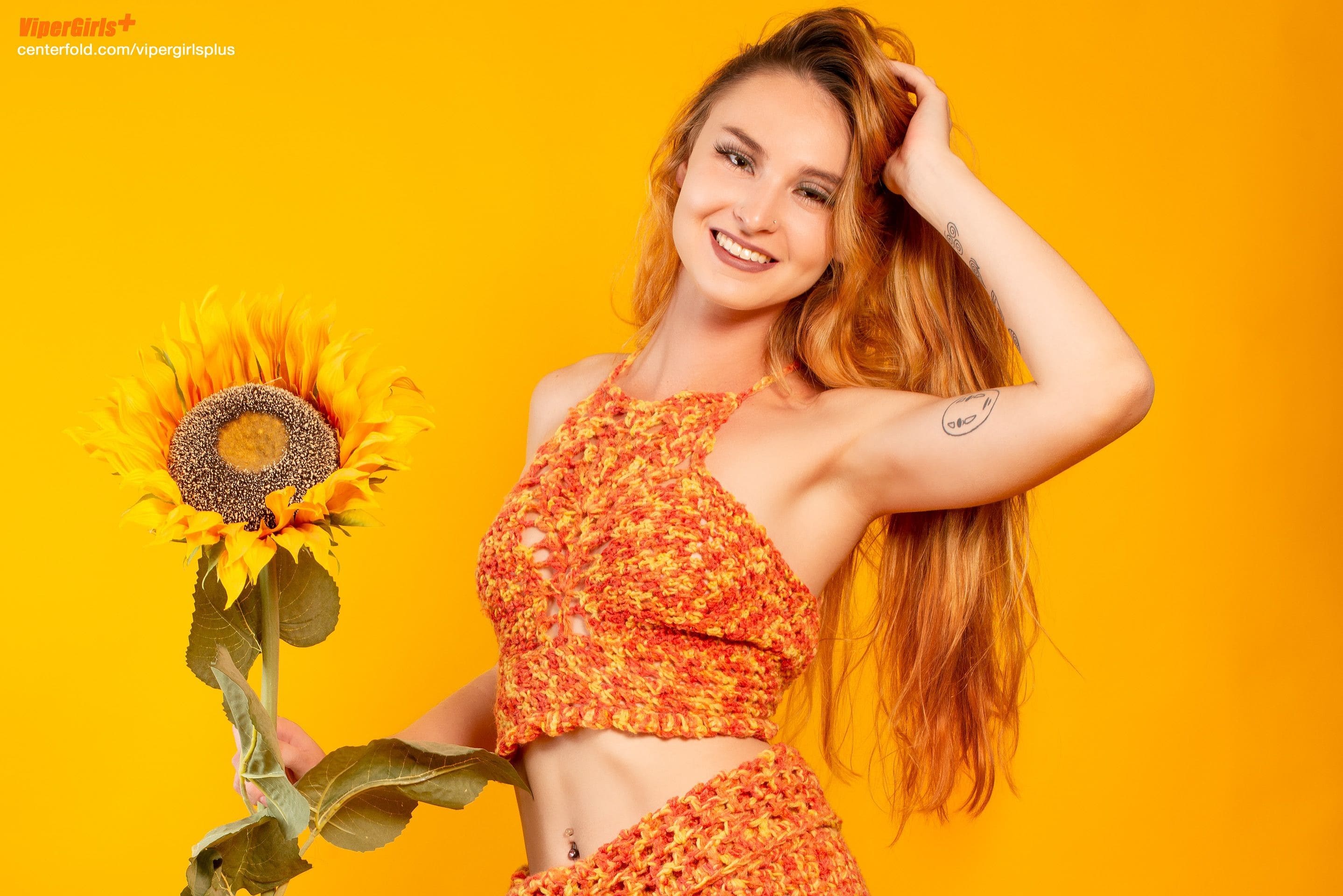 model kayleigh anne wilson with vipergirlsgirlsplus wearing a knit top and skirt holding sunflowers. see more at centerfold.com/vipergirlsplus
