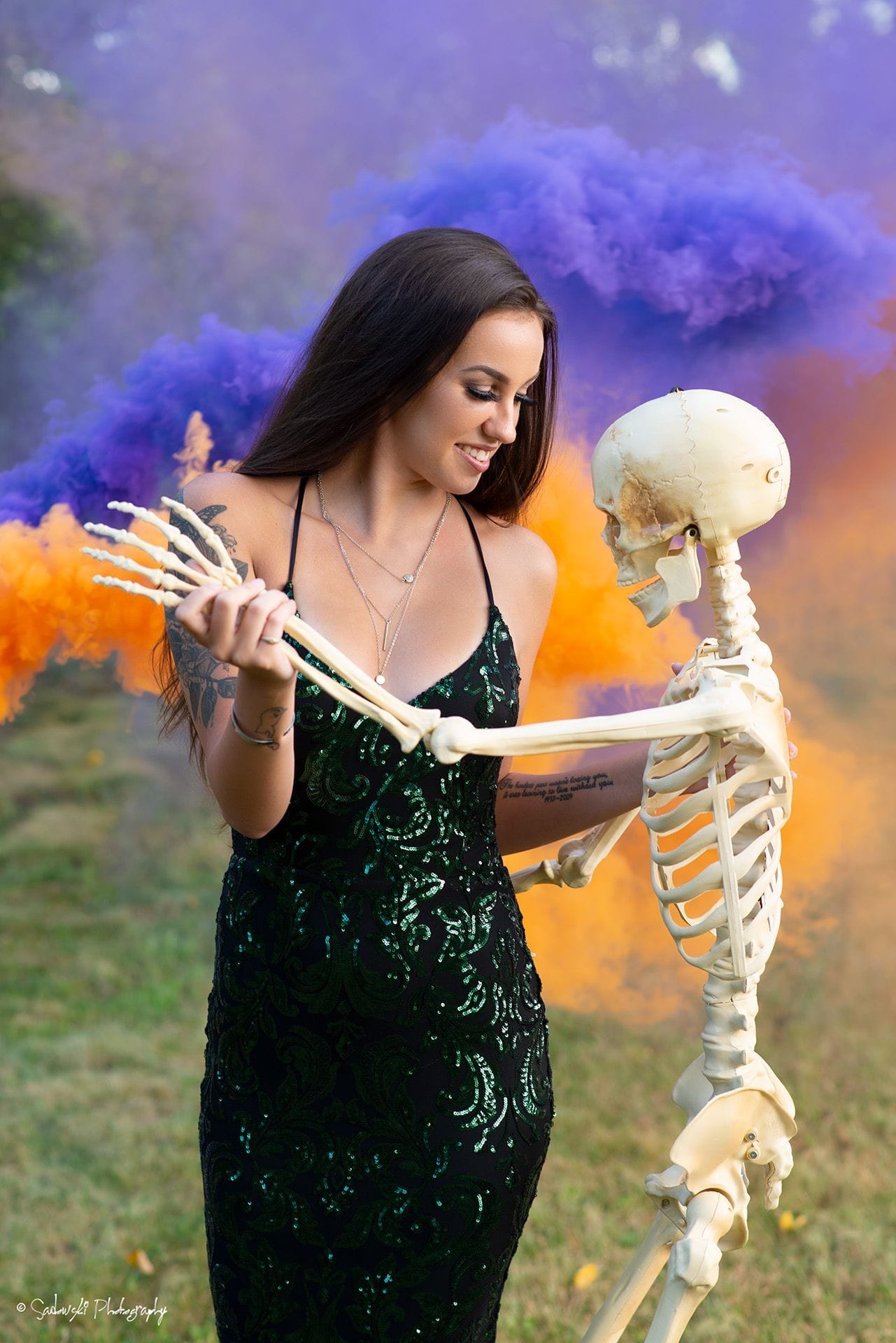 ViperGirl Haley in a green dress with purple and orange smoke bombs. Fashion, beauty and glamour.